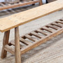 Close-up of the Vintage Teak Bench’s slatted shelf, showcasing its sturdy craftsmanship and practical storage solution.