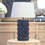 Foliole distressed black hand-carved wooden table lamp with taupe shade on round table