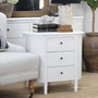 Angled view of the Creemore 3 Drawer Bedside in White, showcasing its sculpted body and tapered legs