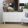 Angled view of the Creemore 6 Drawer Chest in White highlighting the sculpted body, curved corners and elegant tapered legs.