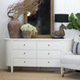 Side-angled view showing the depth, curved frame and clean silhouette of the Creemore 6 Drawer Chest in White.