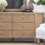 Close-up of the Creemore 6 Drawer Chest drawer fronts, featuring the uniform Weathered Oak finish and understated metal knobs.