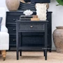 Front angle of the Black Brielle rattan 1 drawer side table bedside styled with a lamp and décor, showcasing the contrast between black timber and natural rattan texture.