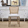Front view of the Noda Rattan Chair with optional Blue Stripe Cushion, showcasing the classic ticking stripe, shaped seat pad and relaxed coastal styling.