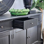 Close up view of the metal drawer runners of the Louis Curved Sideboard in black