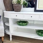 Louis Curved Console Table angled view highlighting the rounded ends, white finish and elegant open shelving.