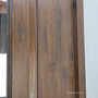 Close-up capturing the aged patina and artisanal finish on the mirror’s wooden surface.