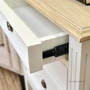 Angled view of the bedside table, displaying its smooth metal runner drawers, combining functionality with style.