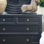 Detailed shot showing the smooth satin-black finish on the top surface of the dresser.