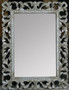 The silver Laurent Mirror, adorned with a distressed patina and intricate carvings, brings a timeless, Hamptons-inspired elegance to living room decors, courtesy of Canalside Interiors