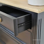 Detail of the metal runners on the drawers, showcasing the blend of traditional aesthetics with modern functionality.