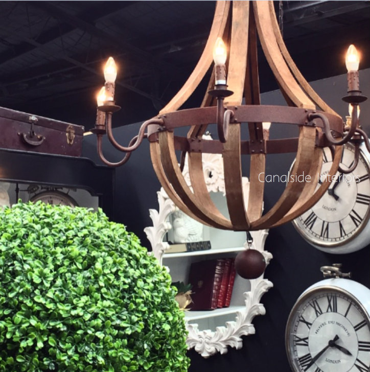 Angled view of the chandelier, emphasizing the rusted bronze finished metal that adds a touch of grandeur to the rustic design.