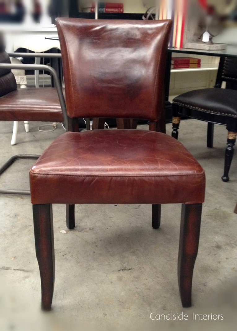 Featuring a robust build and studded accents, this Leather Dining Chair embodies the quality and timeless design championed by Canalside Interiors