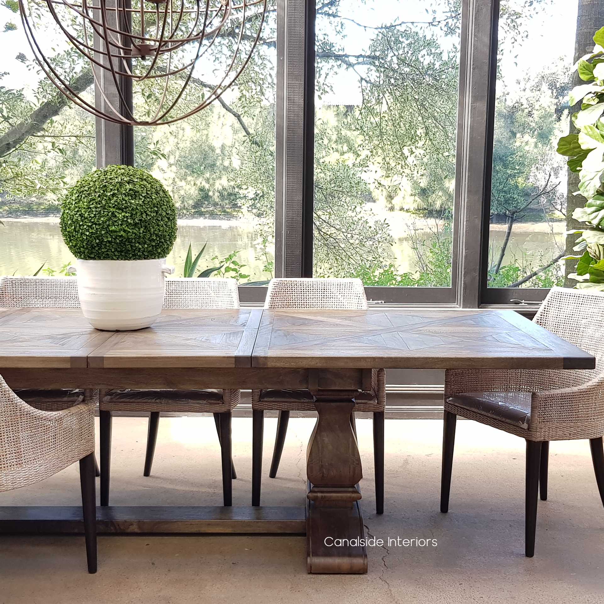 Set of Wickham Dining Chairs around a rustic table, creating an inviting dining space that mixes textures and styles harmoniously.