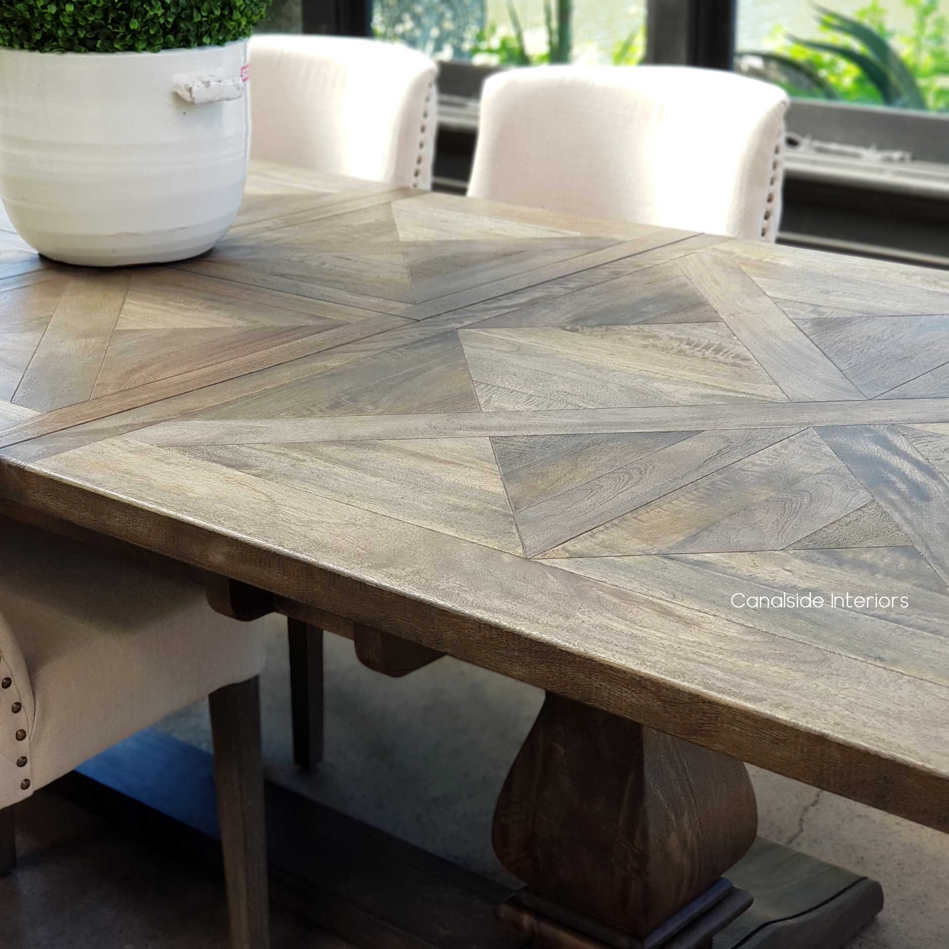 The Bridgehampton Dining Table, poised in dark cedar, showcases the elegance of the Hamptons, perfect for a coastal-themed living room - Canalside Interiors