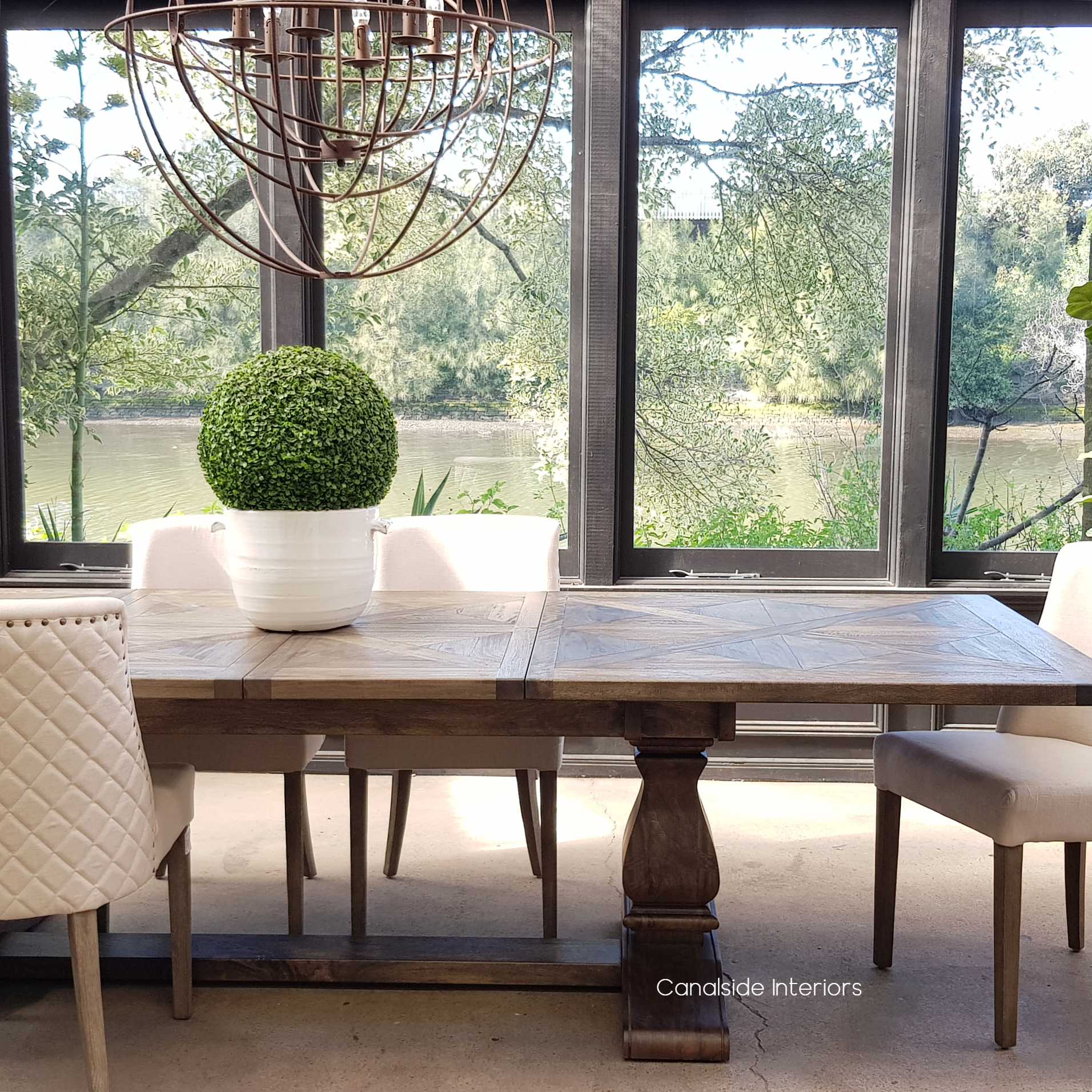 The Bridgehampton Dining Table, a testament to timeless quality, with its extendable design and rich color, brings modern functionality to classical themes 