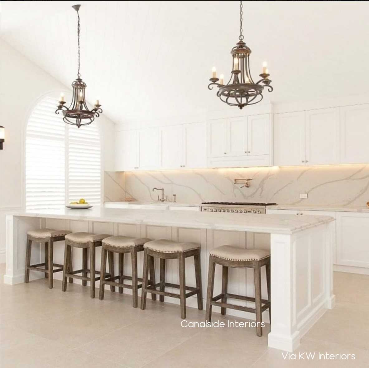 Mila II Stool displayed as a group by a kitchen island, showcasing how it complements Hamptons and coastal interiors with its elegant design.