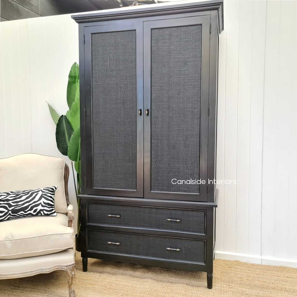 Angled perspective capturing the wardrobe's stature and detailing, perfect for adding a statement piece to any room.