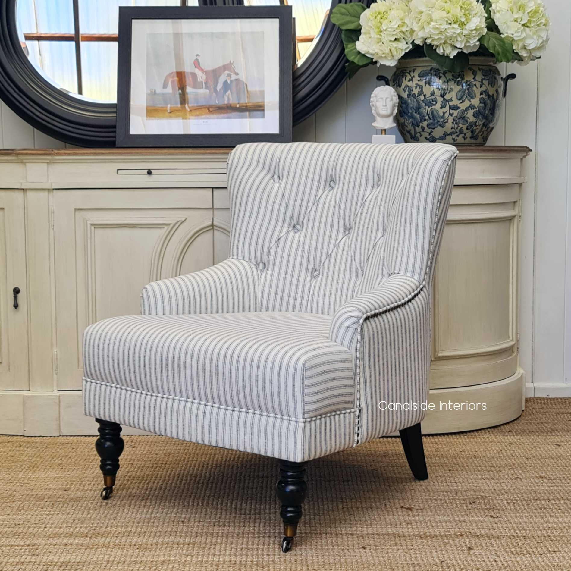The Ascott Armchair in a living room corner, inviting relaxation with its comfortable linen blend and stylish design.