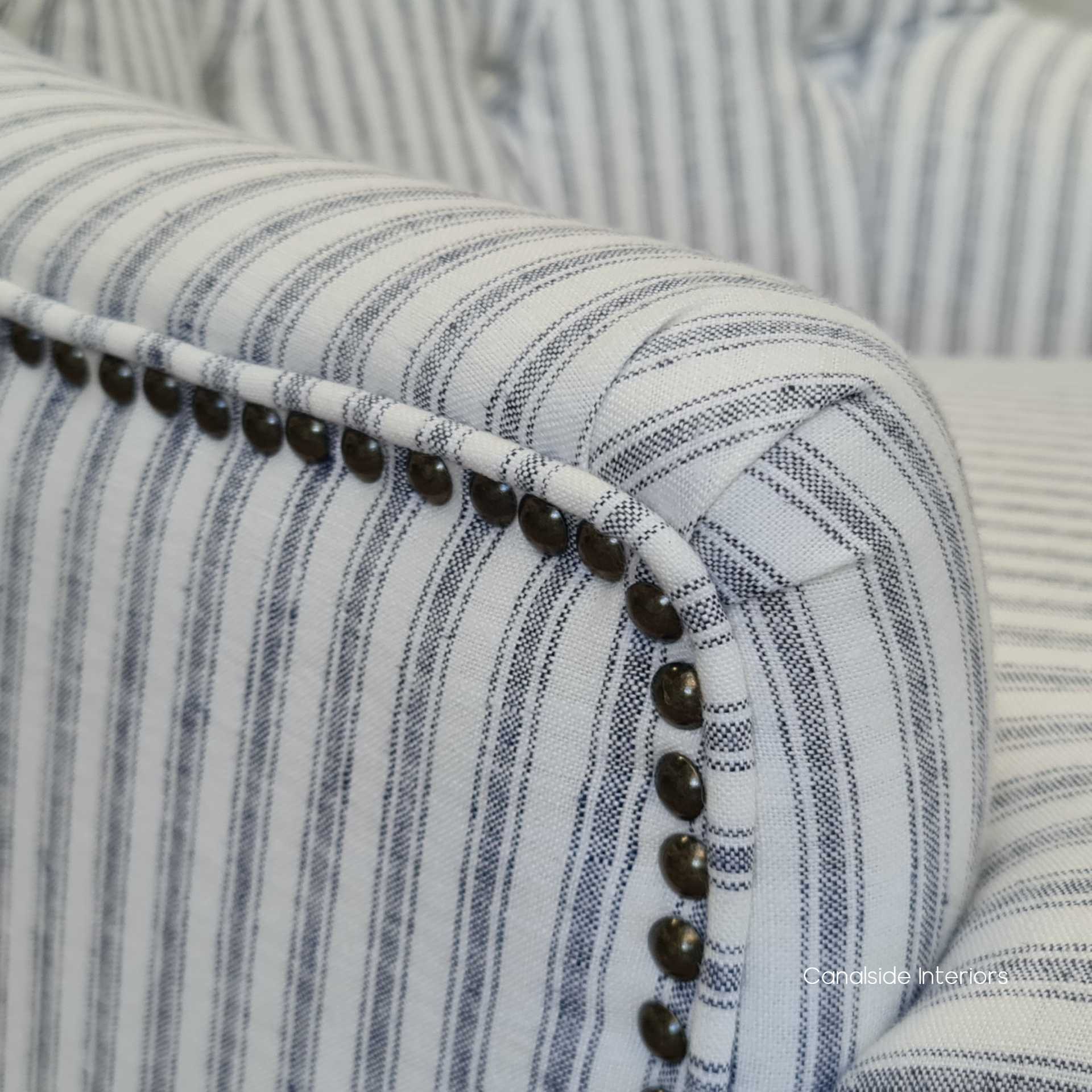 Close-up of the chair's linen blend upholstery, reflecting the quality materials and comfortable texture.