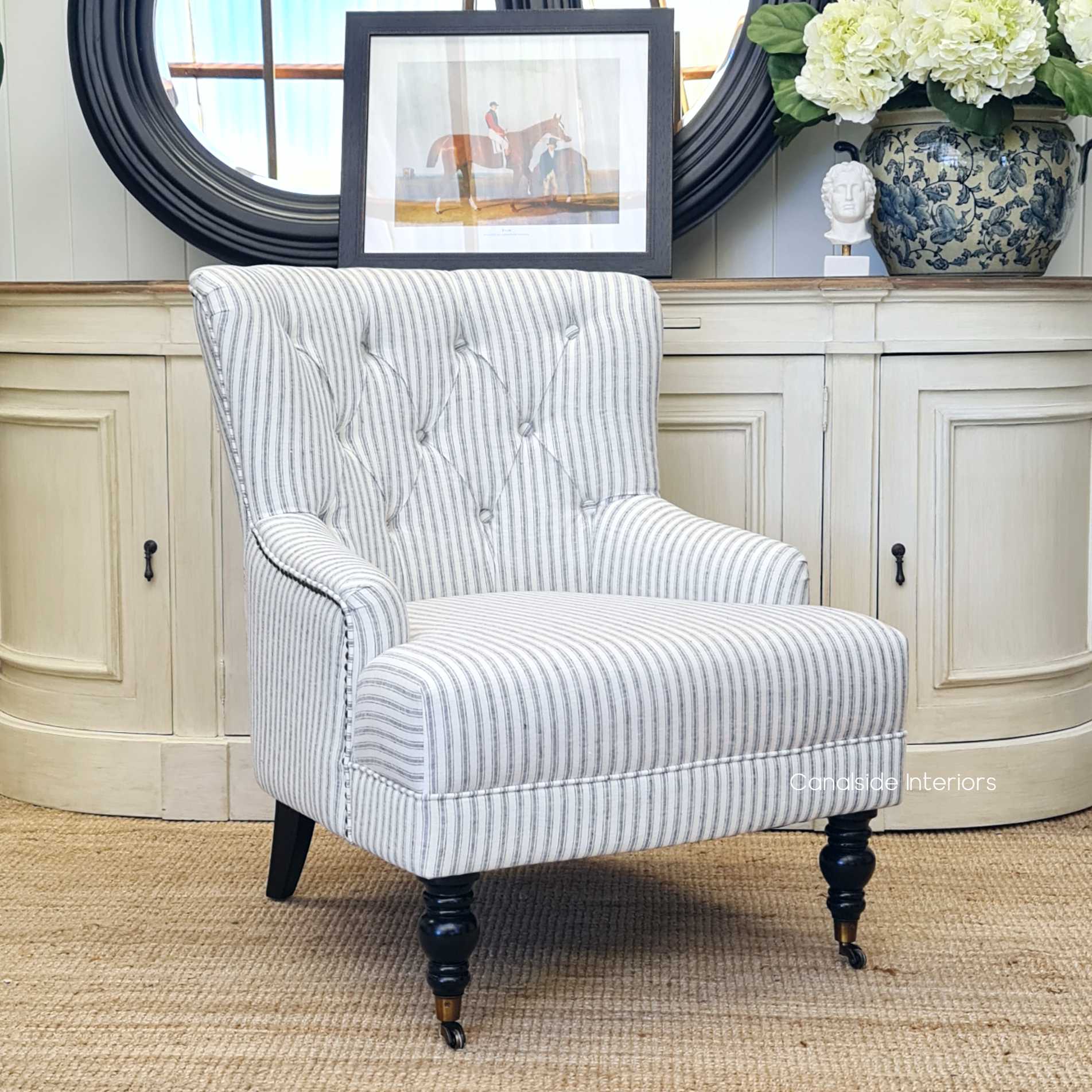 The Ascott Armchair in a living room corner, inviting relaxation with its comfortable linen blend and stylish design.