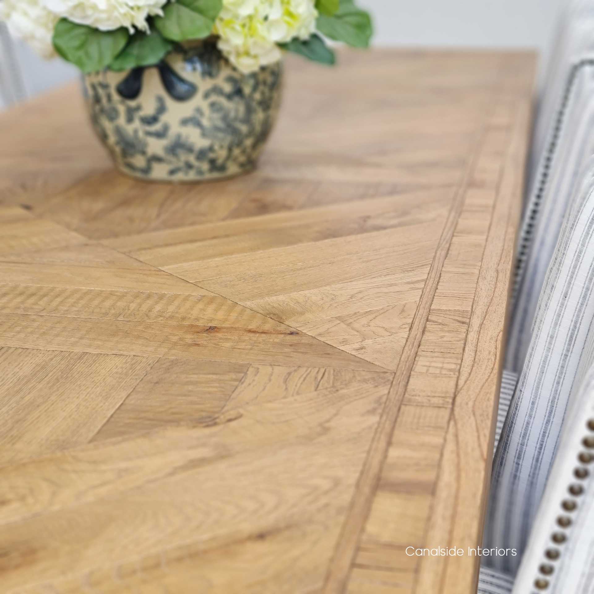 Admire the intricate parquetry of the Danbury Oak Dining Table, hand-crafted to perfection, making every meal a luxurious occasion