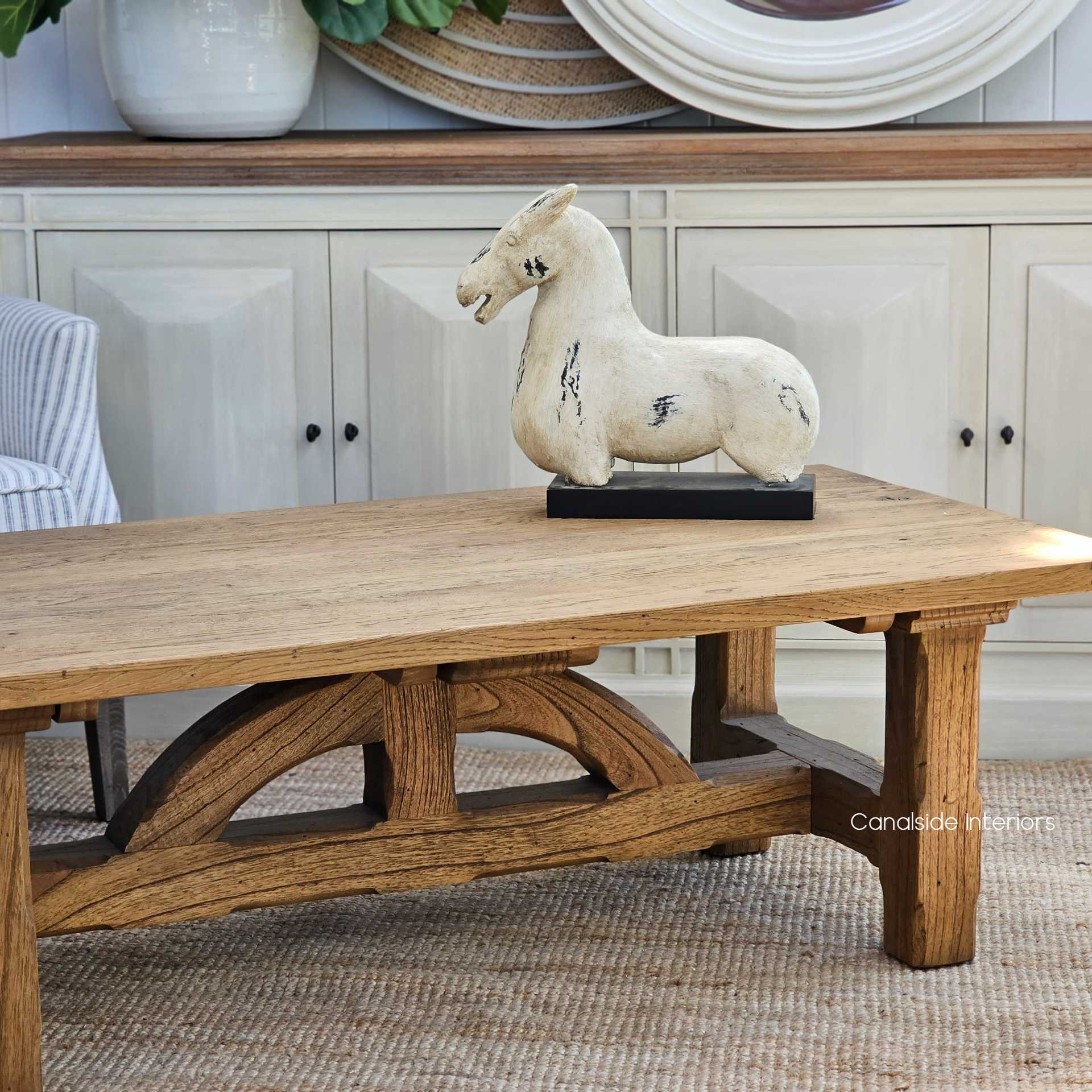 Corner shot of the Treadstone Coffee Table, where its natural rustic timber beams complement the classical decor of a bedroom or reading nook