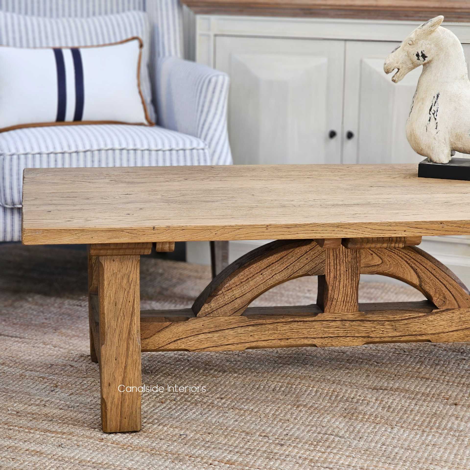 Angular view of the Treadstone Coffee Table, illustrating how its robust silhouette anchors a library or home office space