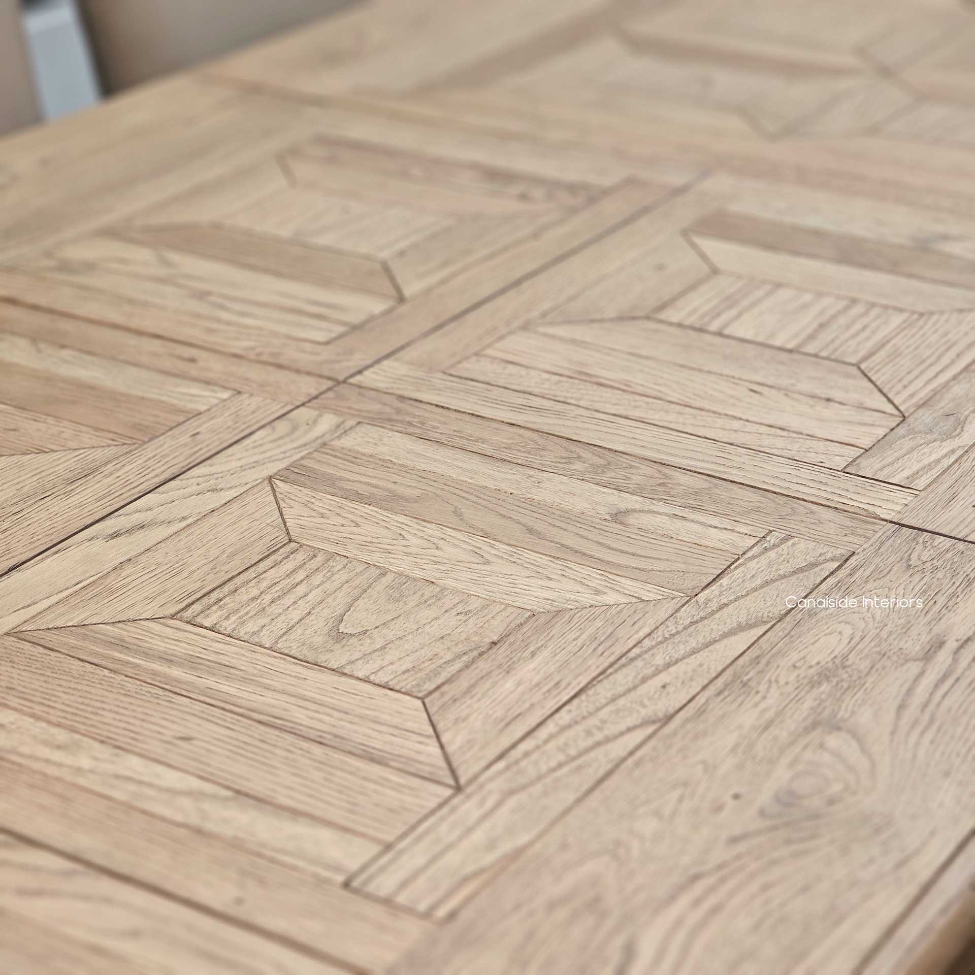 Zoom-in on the oak grain and parquet joins – Emphasising the texture, tone, and expert alignment of each timber piece for a premium finish.