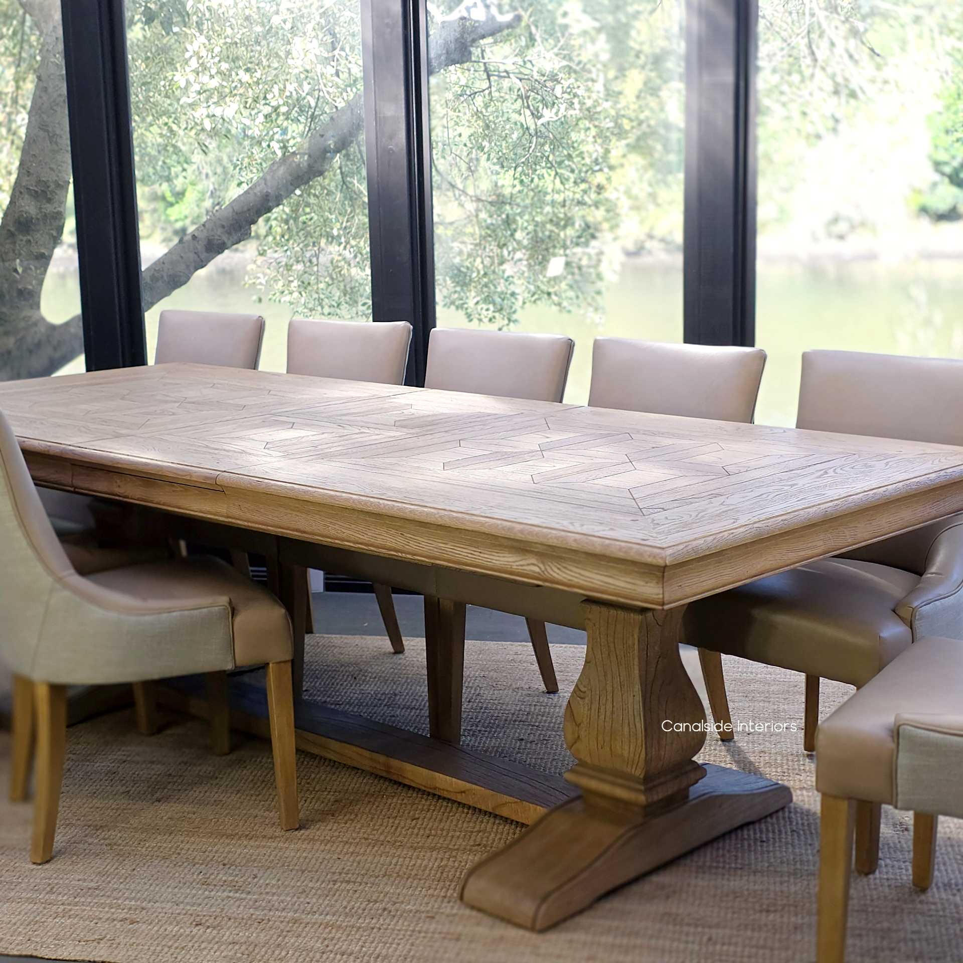 Chesterton parquetry oak dining table shown with one extension in use.