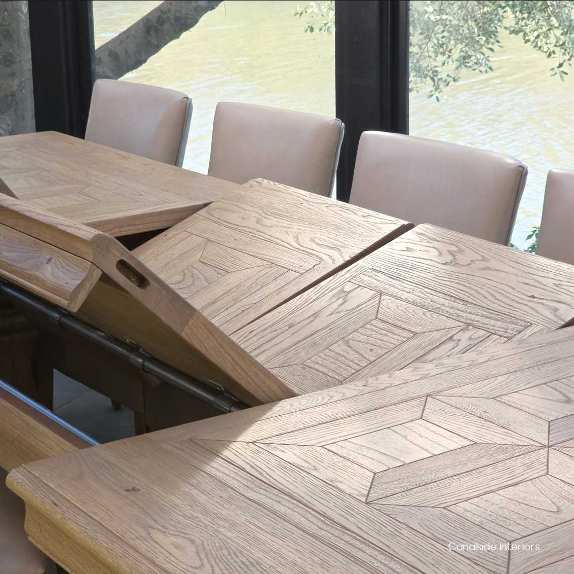 Close-up of smooth butterfly extension mechanism on the Chesterton oak table.
