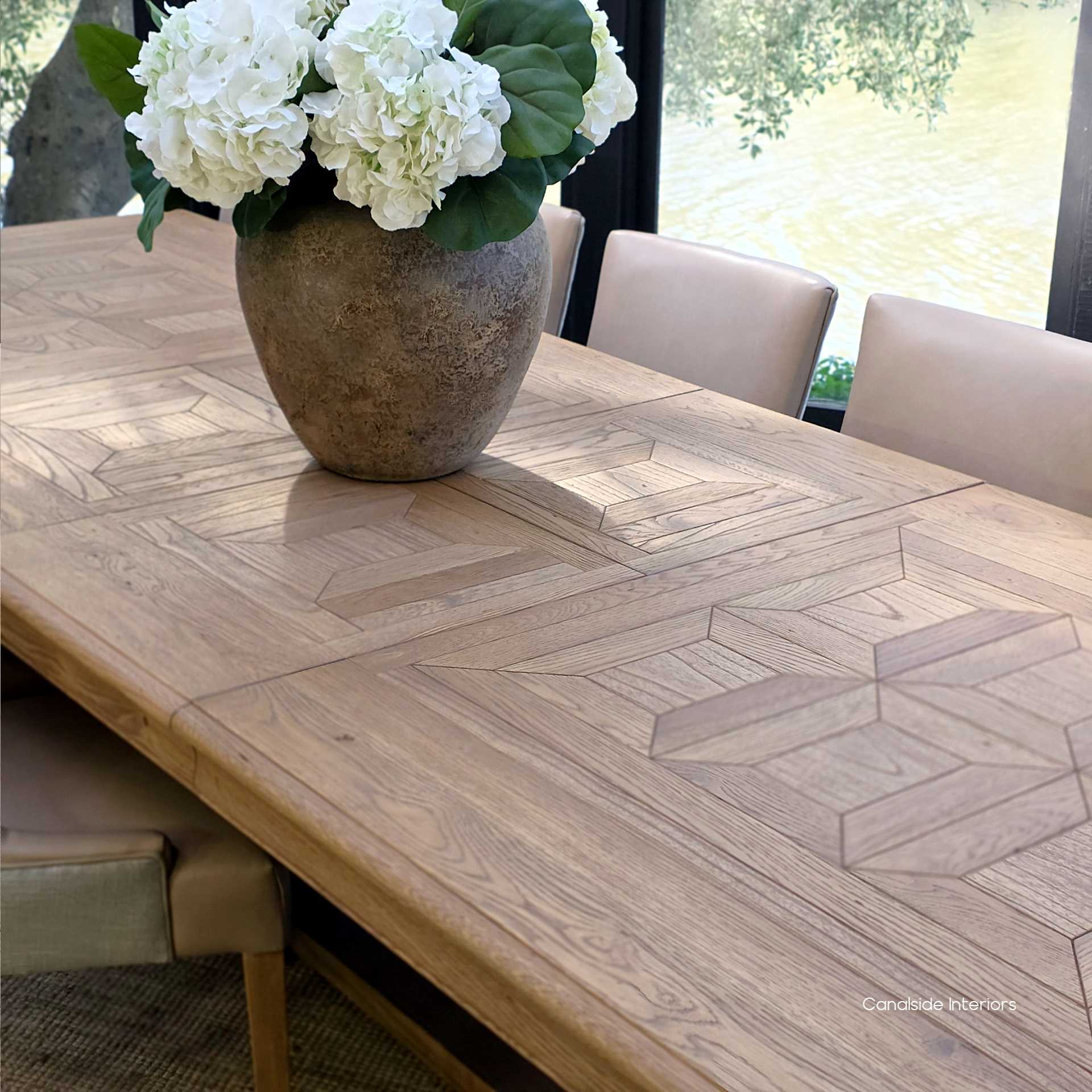 Overhead shot of oak parquetry top in natural light on the Chesterton dining table.