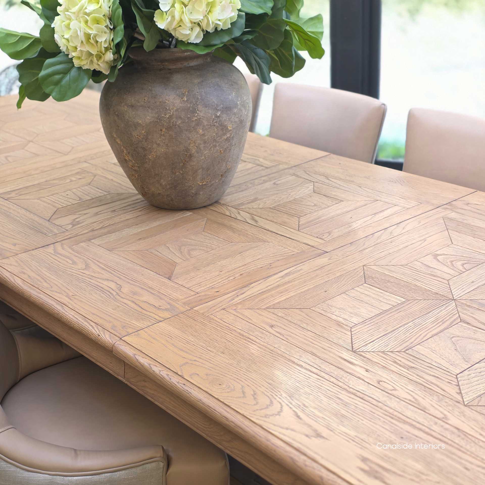 Overhead view of oak parquetry pattern on the Chesterton extendable dining table.