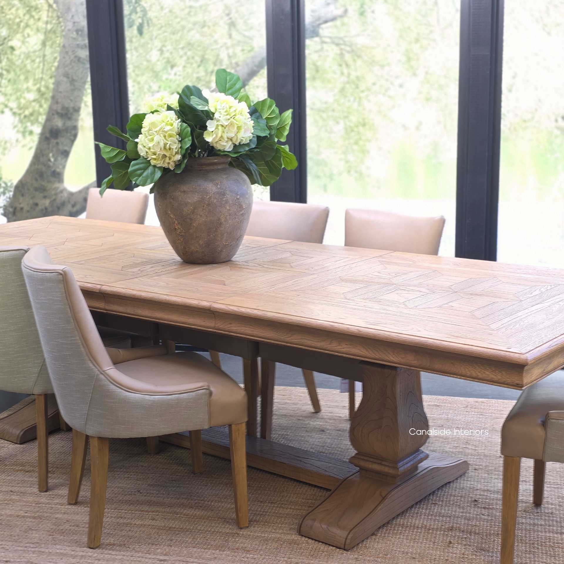 Chesterton oak parquetry table with both extensions open for banquet dining.