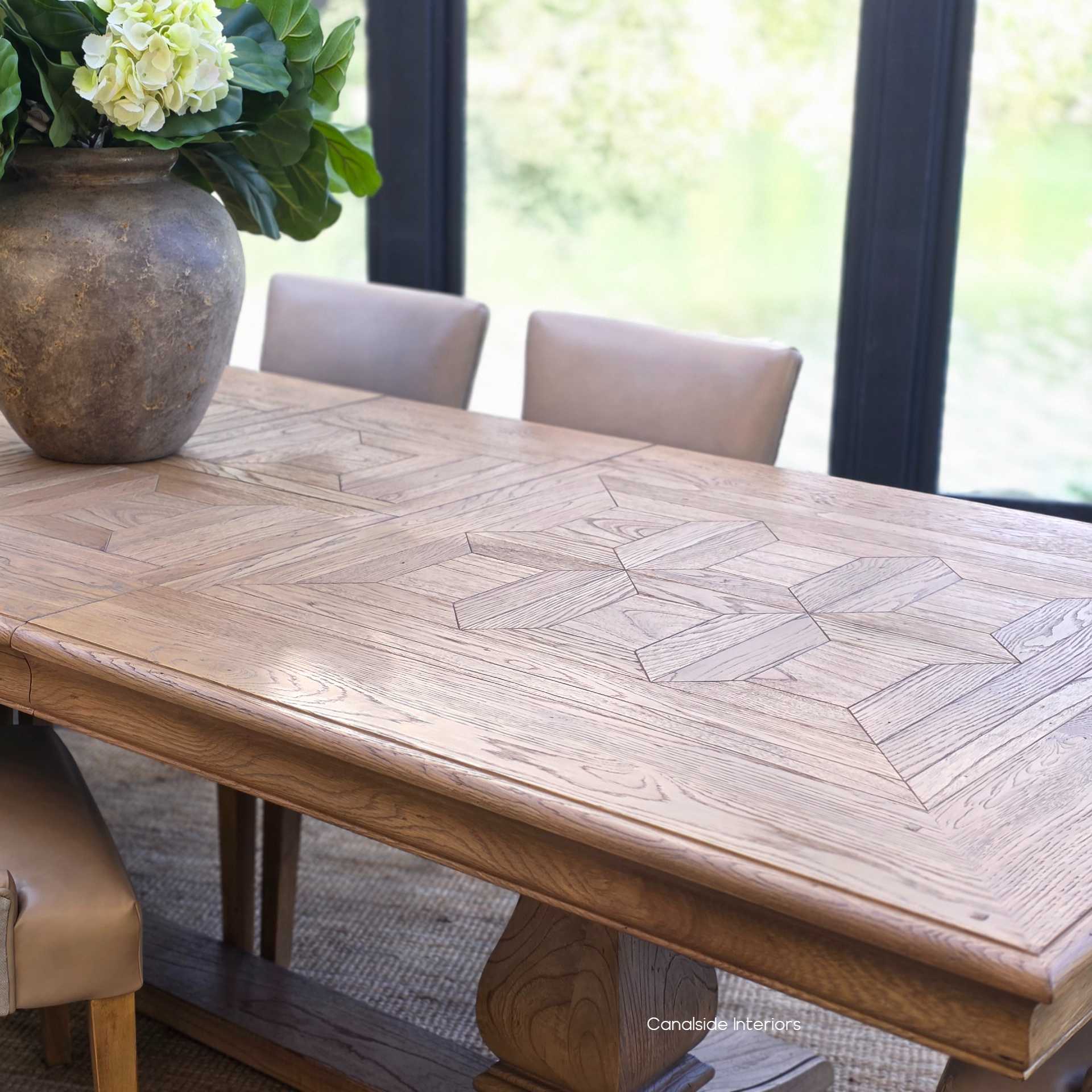Close-up of parquetry border detail and oak grain on the Chesterton dining table.