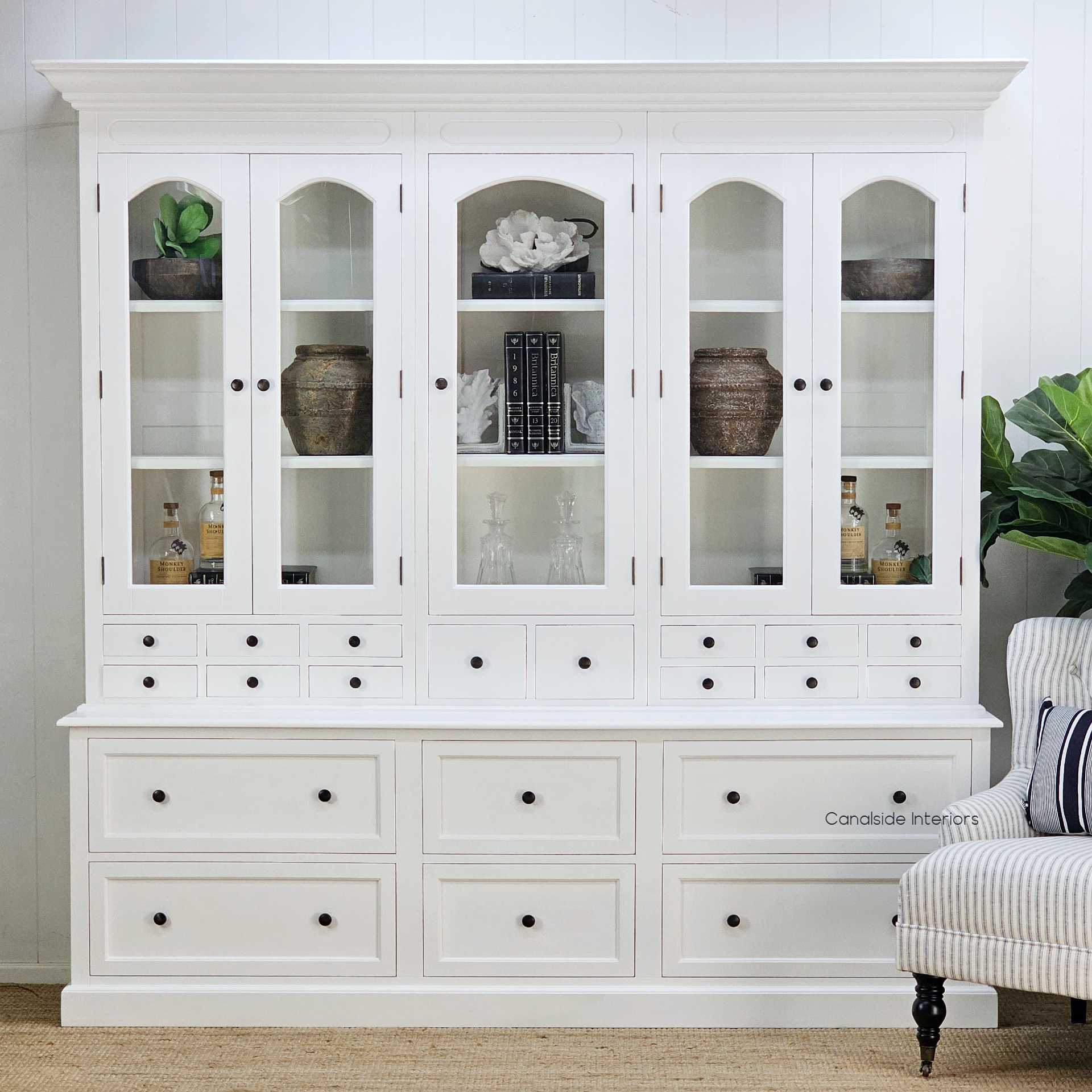 Full frontal image highlighting the five arched glass-panel doors and lower drawer layout. Elevate your dining room with the Key Largo 5 Door Display Unit with Drawers in classic white, reflecting Canalside Interiors' dedication to Hamptons elegance