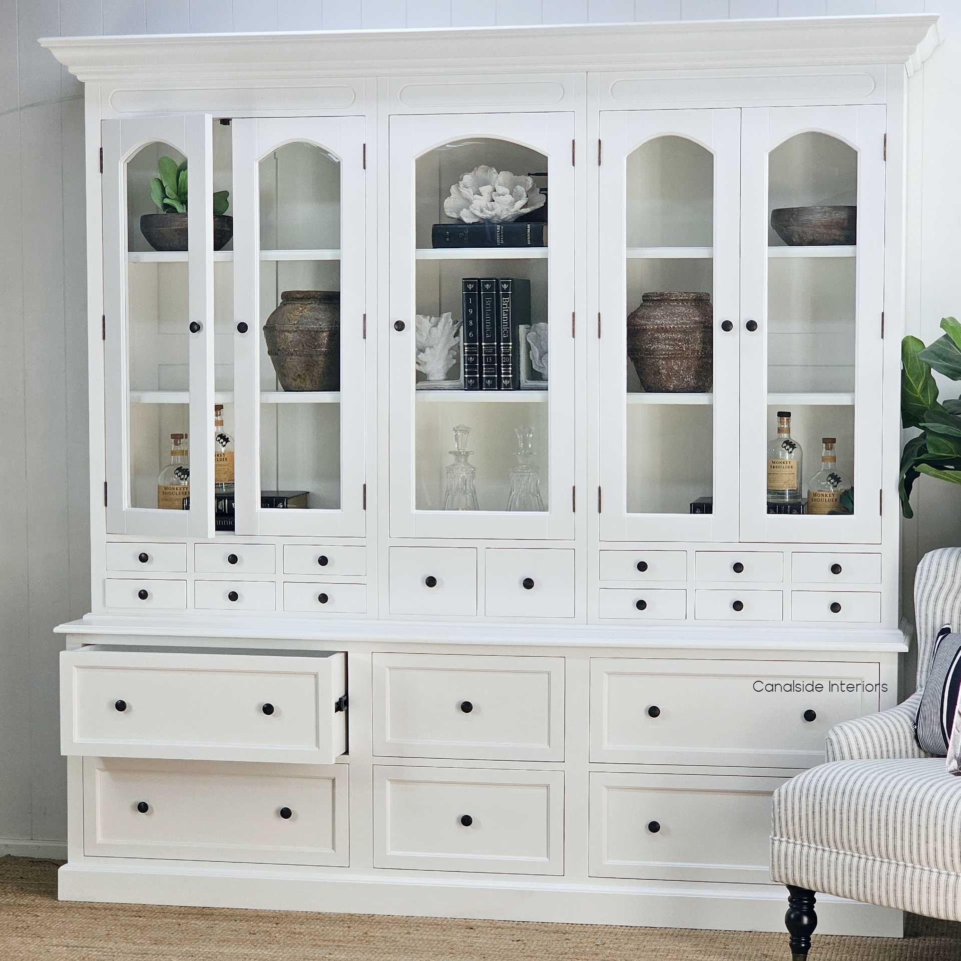 Display your cherished crockery in the white Key Largo Unit with base drawers, a coastal-themed piece with handcrafted details for a timeless living room – Canalside Interiors
