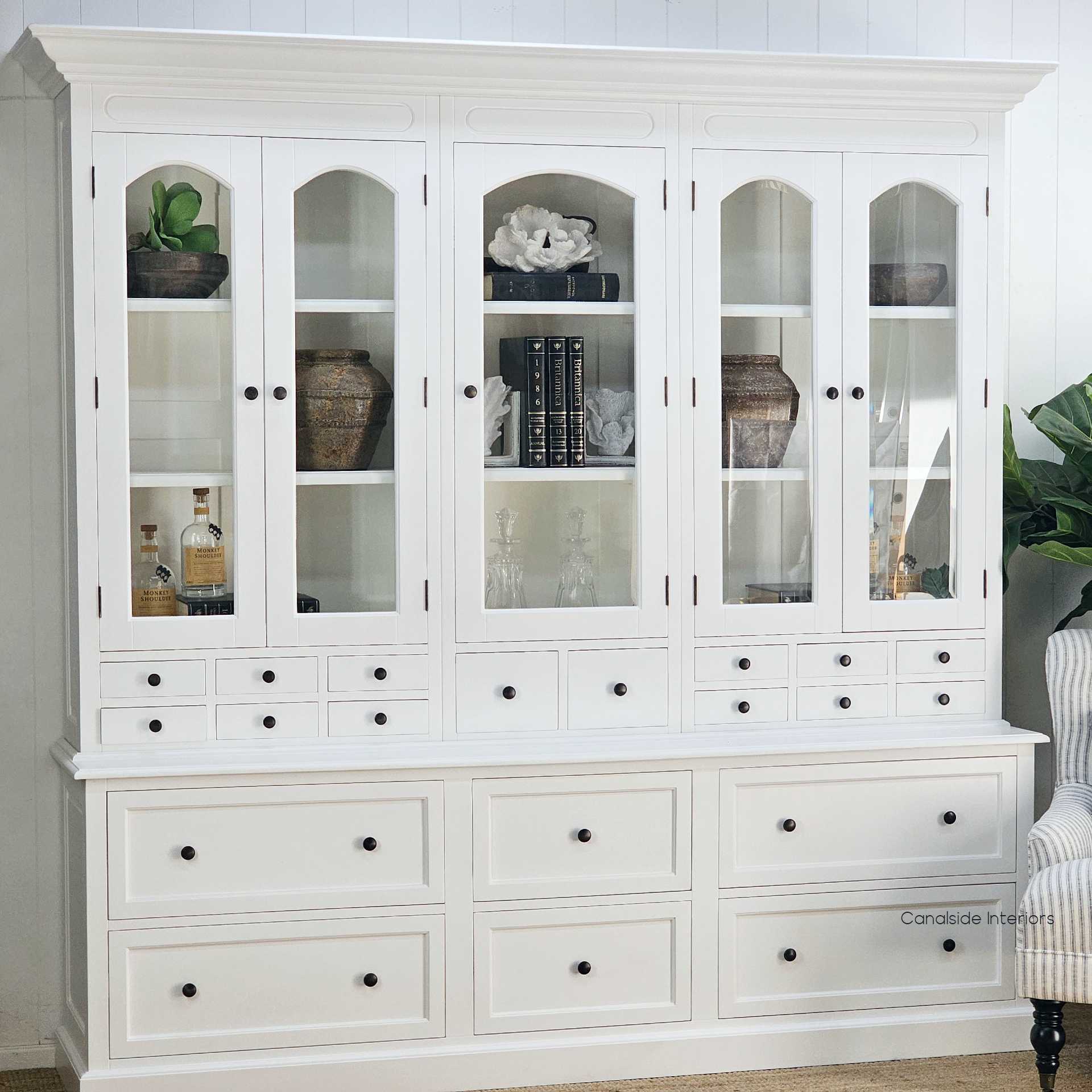 Display unit shown fully styled with books, ceramics, and glassware in a classic Hamptons-inspired setting.