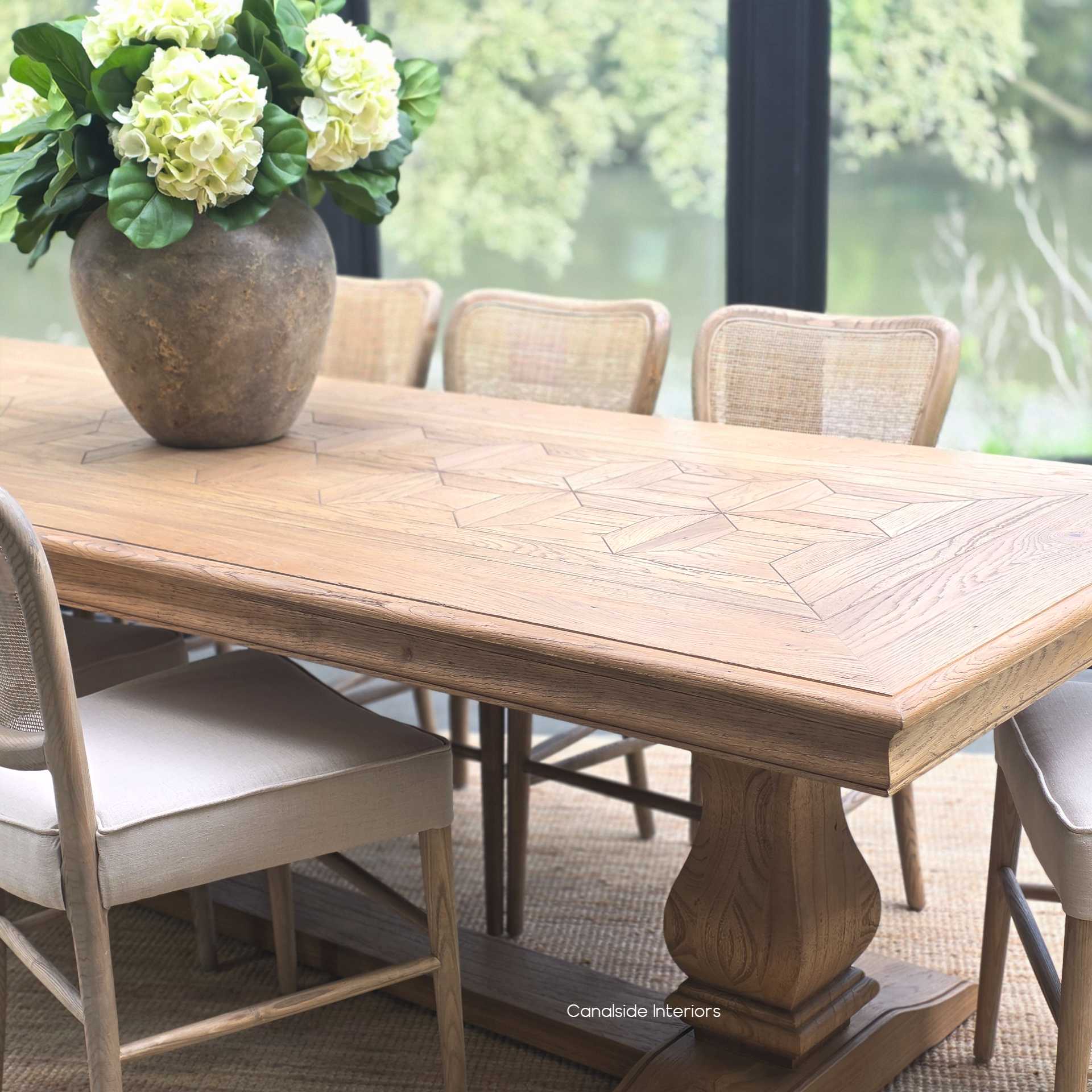 Full room view with the Chesterton table anchoring a formal dining setting.