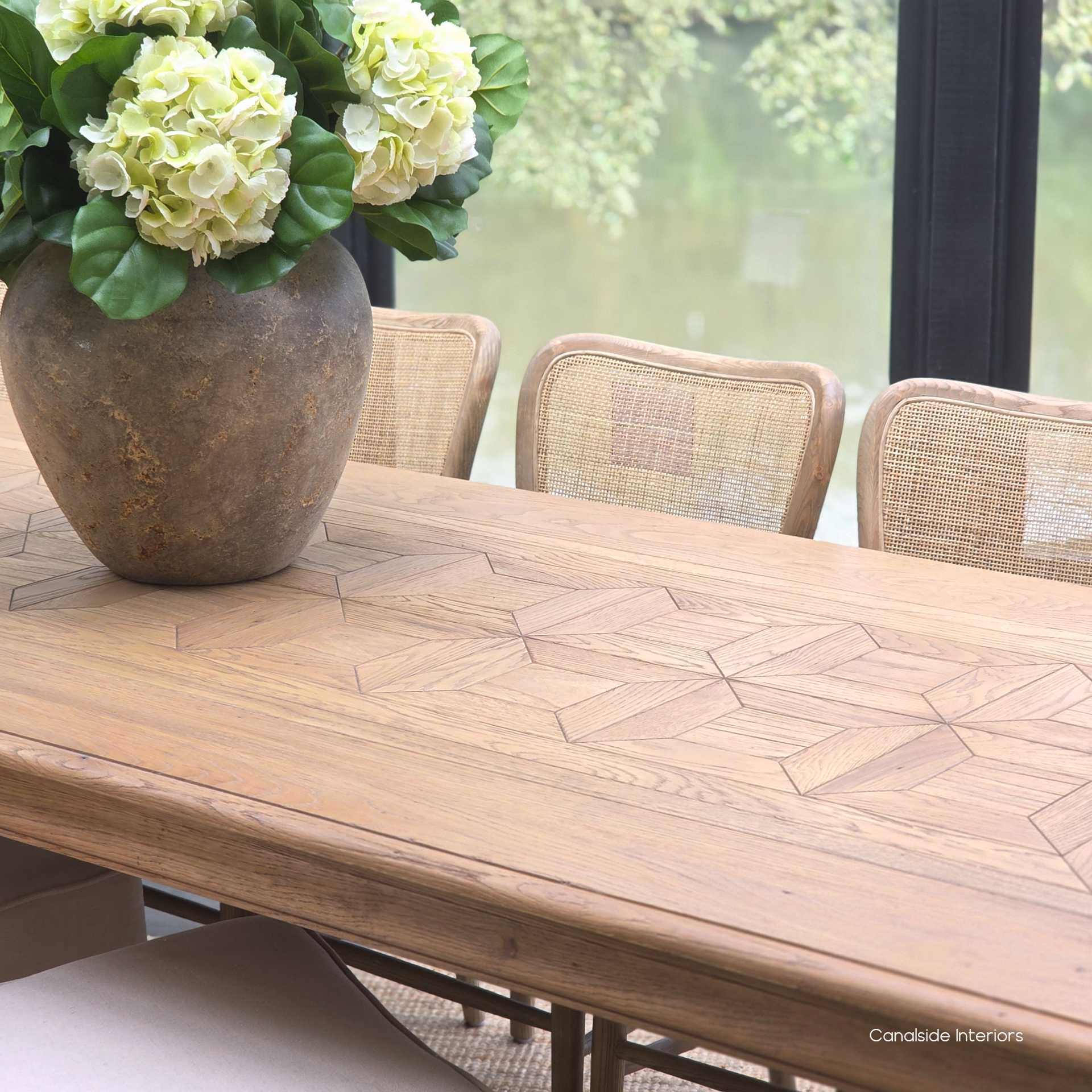 Diagonal close-up of the tabletop emphasising the symmetrical layout of the oak parquetry.