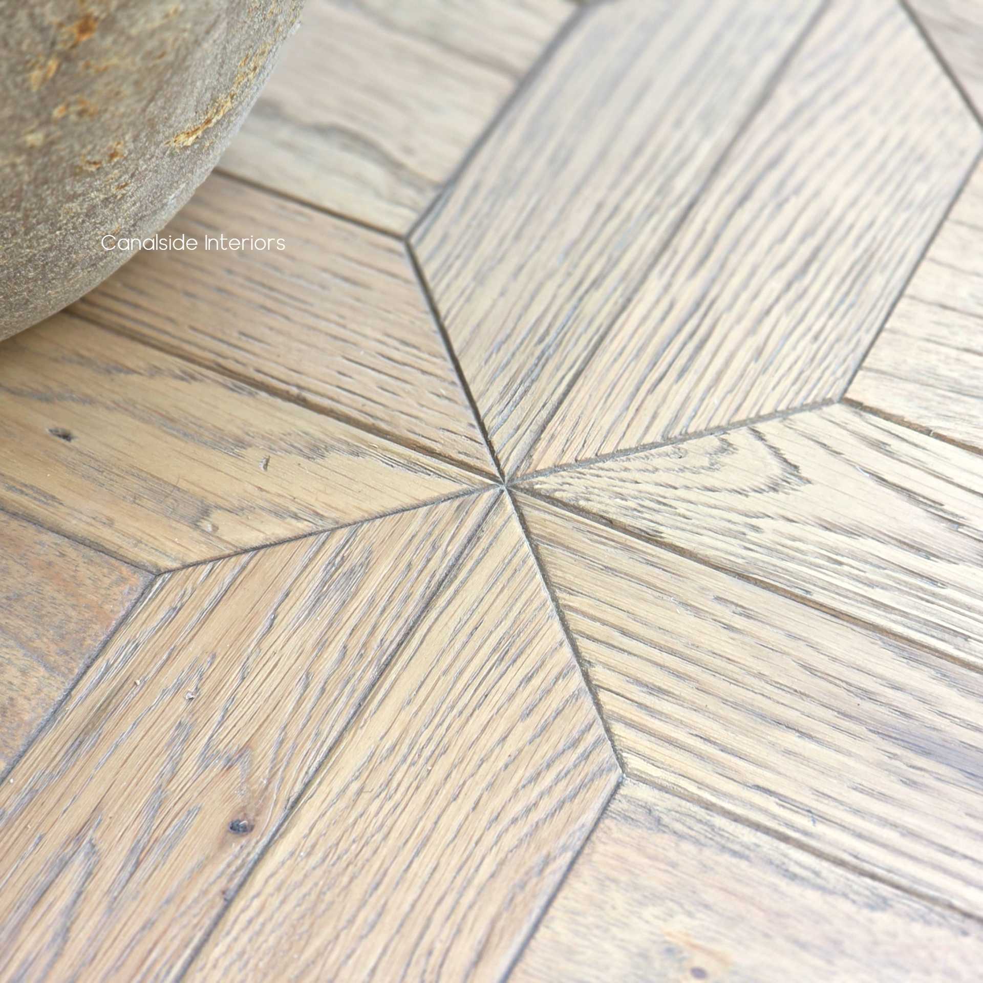 Angled view focusing on the transitions between parquetry panels and the smooth surface finish.