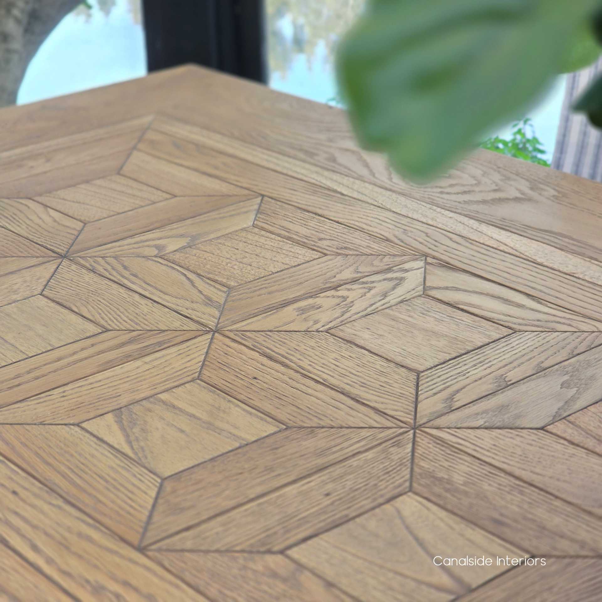 Close-up of the parquetry pattern highlighting the precise hand-laid oak pieces in a traditional design.