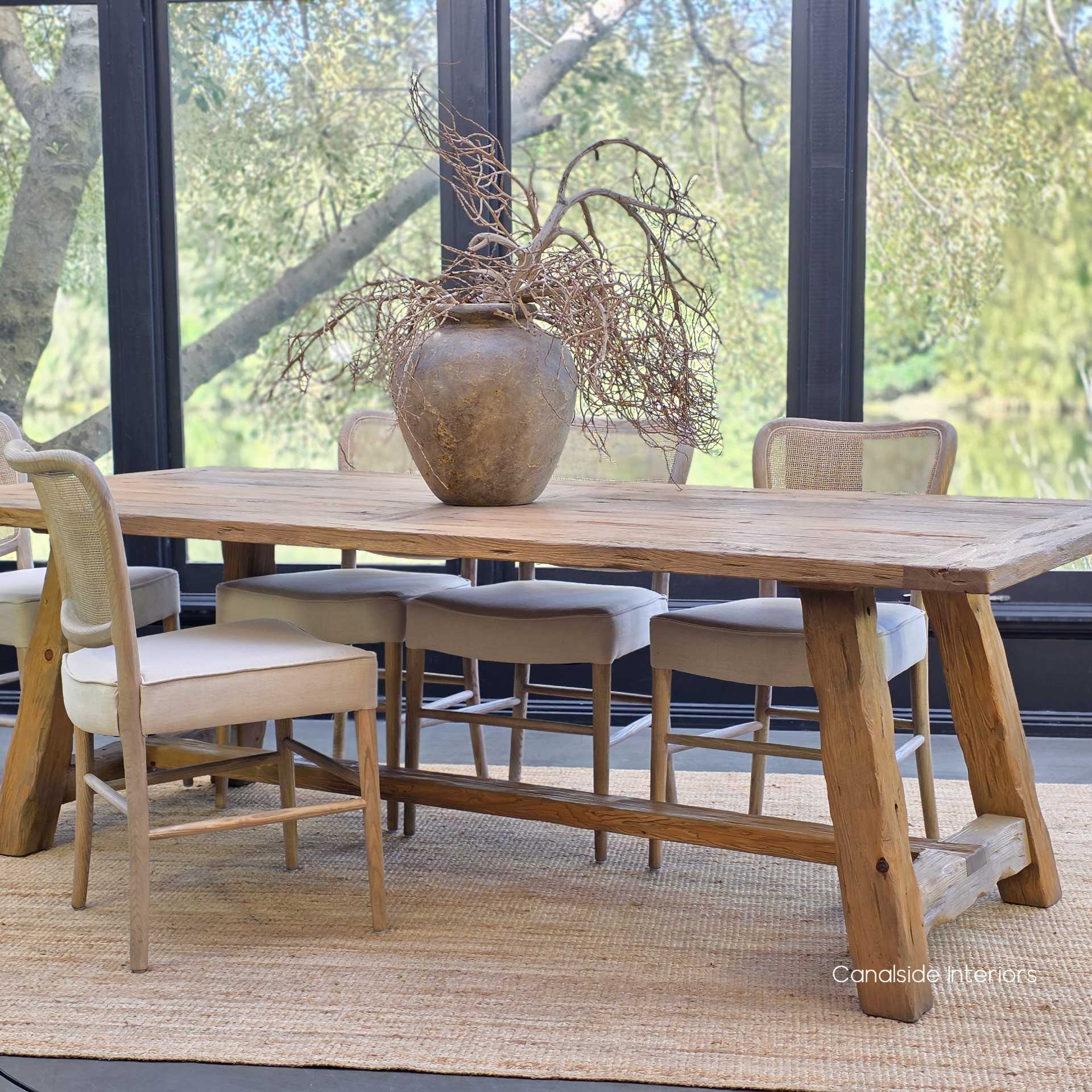 Hollowgrove dining table placed on a jute rug, highlighting tonal harmony.