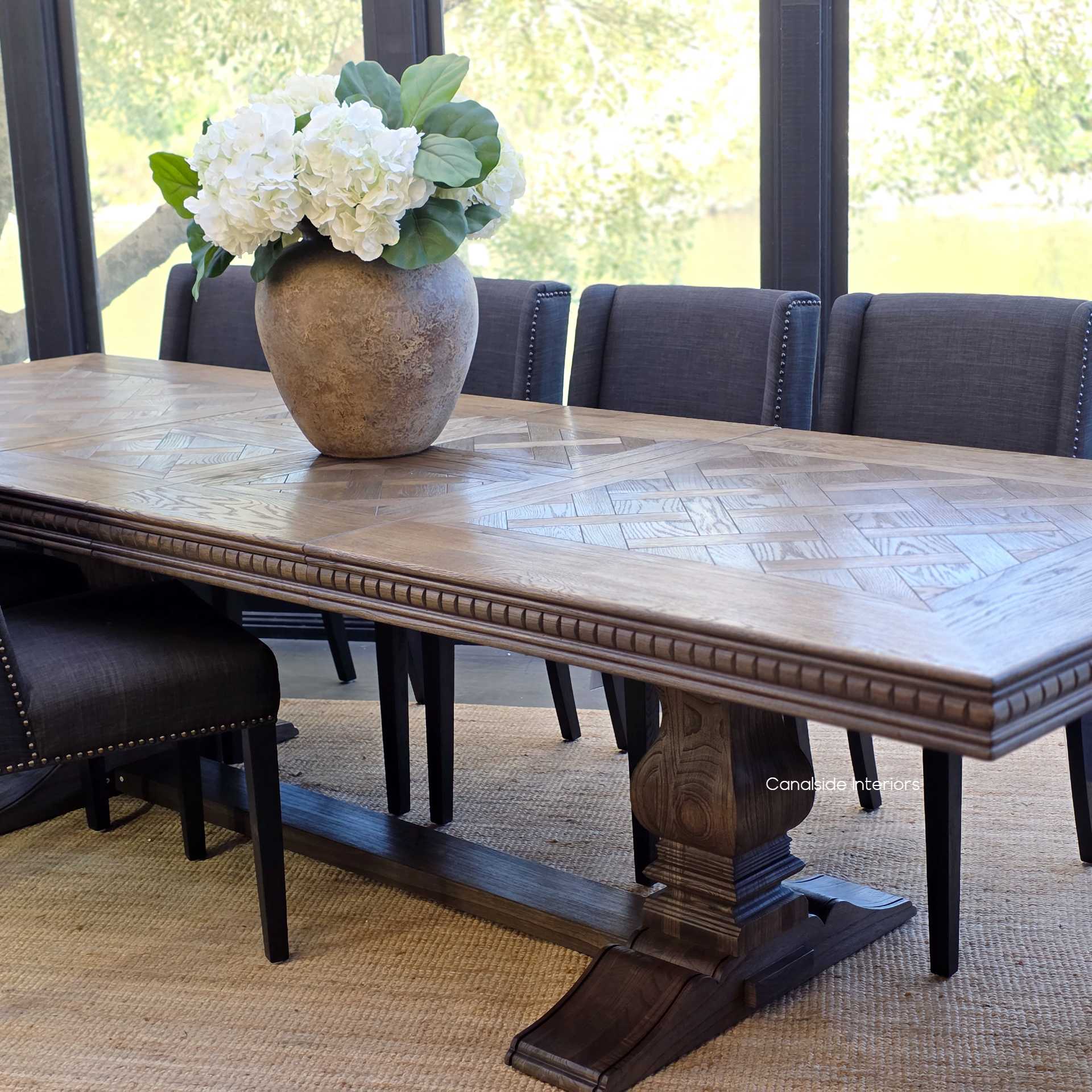 Formal dining setting with Berenson Oak Parquetry Extendable Table in Cigar paired with luxurious upholstered dining chairs.