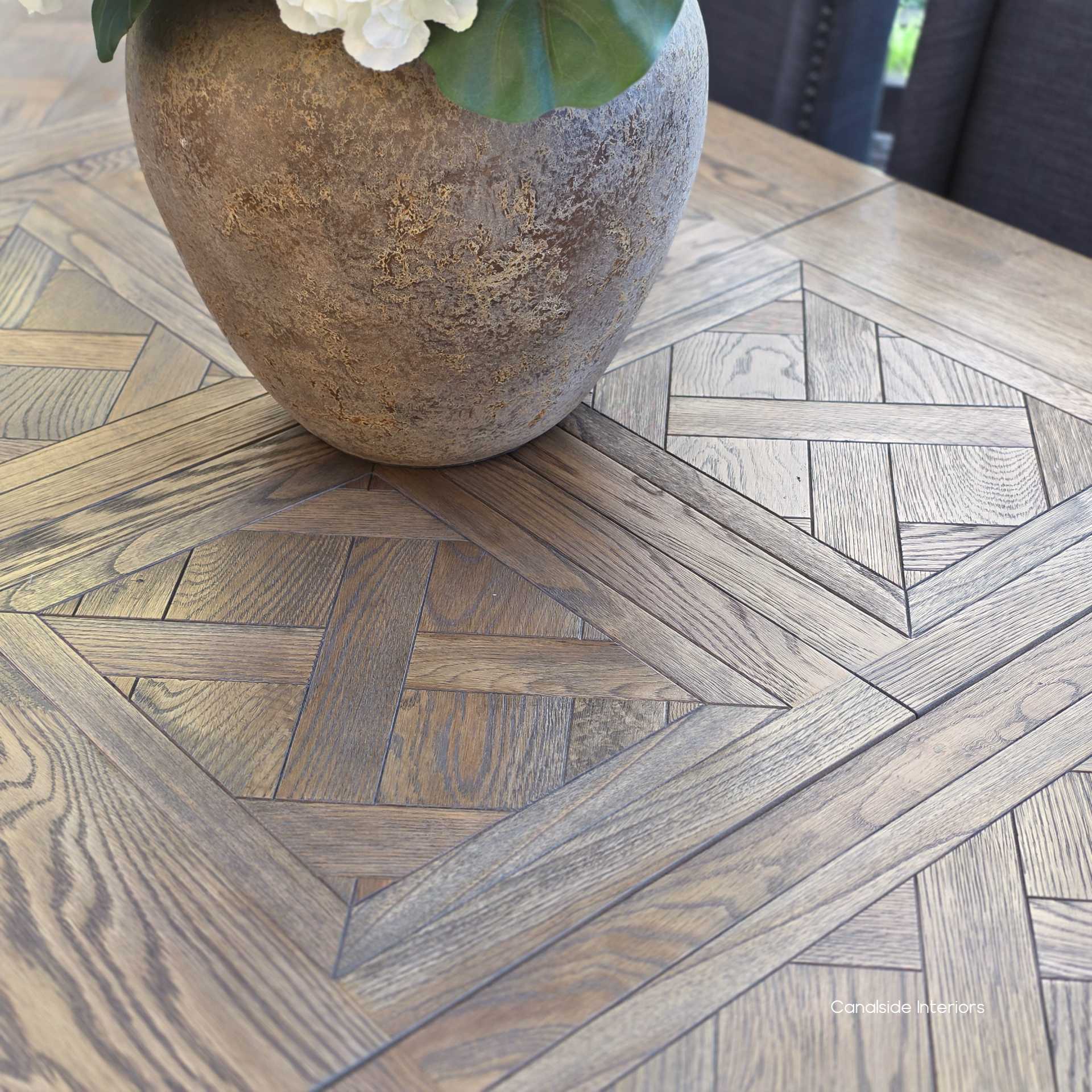 Overhead view of the parquetry oak tabletop in rich Cigar colour.