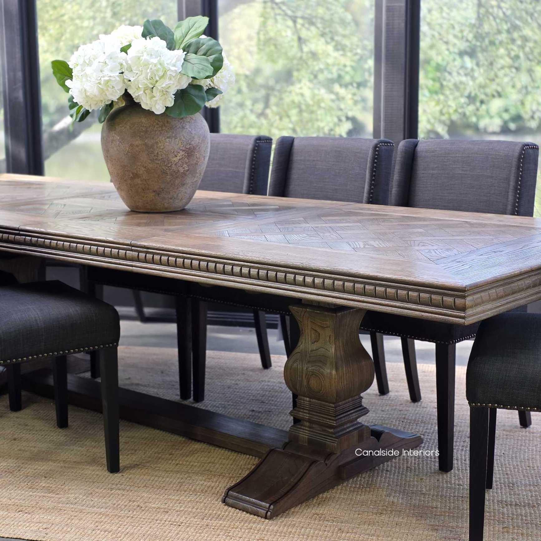 Berenson Cigar oak table in formal dining setting with upholstered chairs 