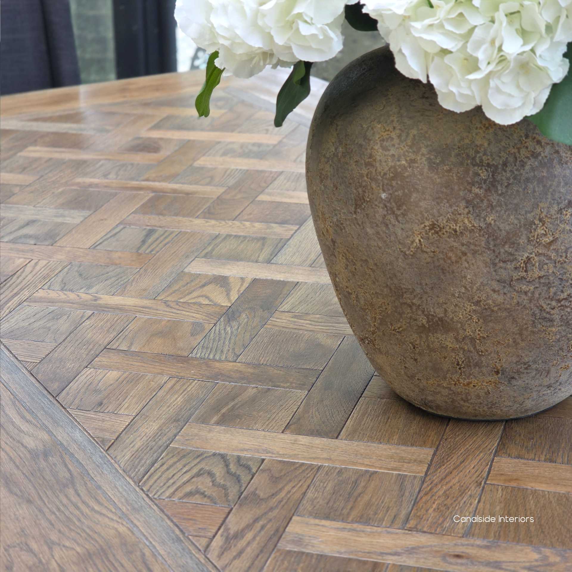 Close-up of hand-laid parquetry top with border inlays on the Berenson 245cm Cigar oak table.