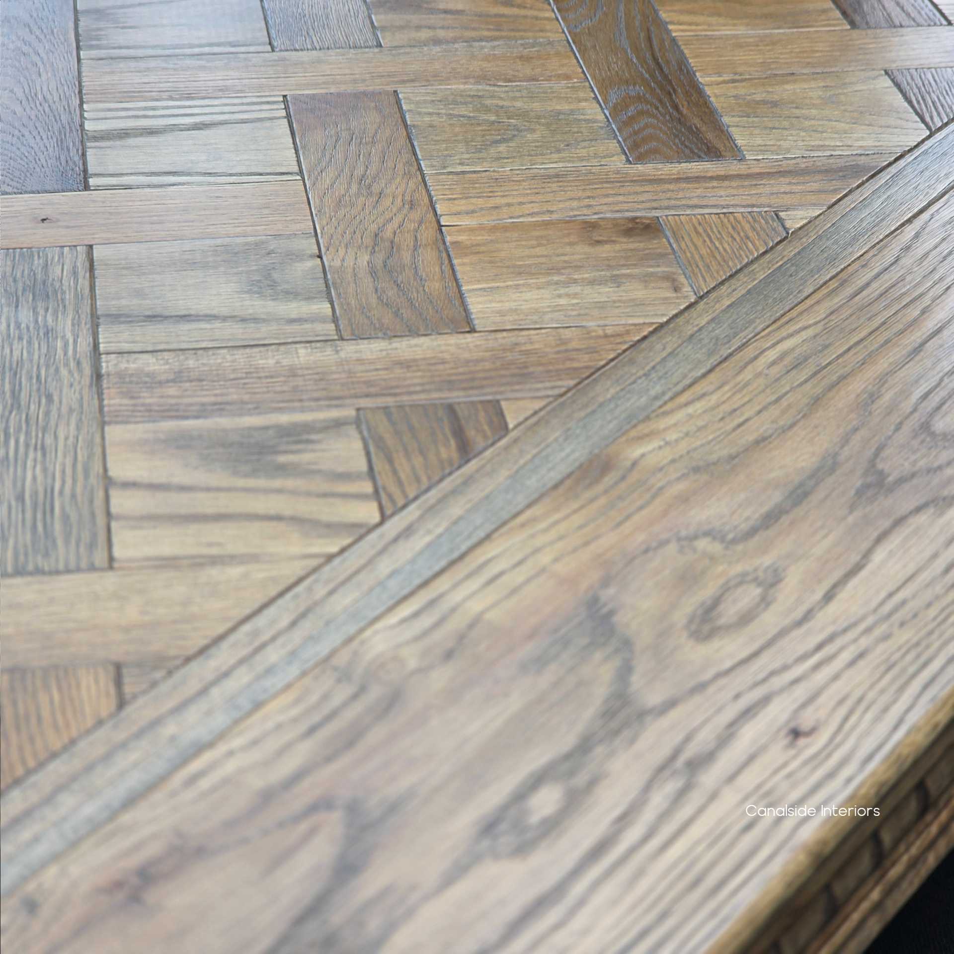 Close-up of parquetry inlays and carved apron craftsmanship on Berenson Cigar table.