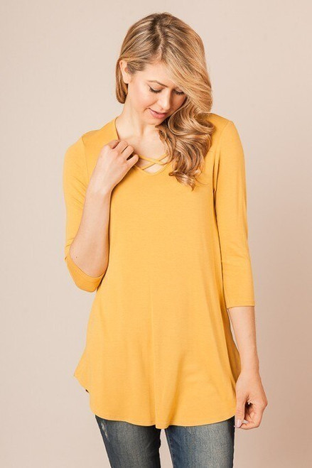 Mustard jersey knit long line maternity top with 3/4 sleeves, crossed strap detail in front, and rounded hem.


Origin : USA