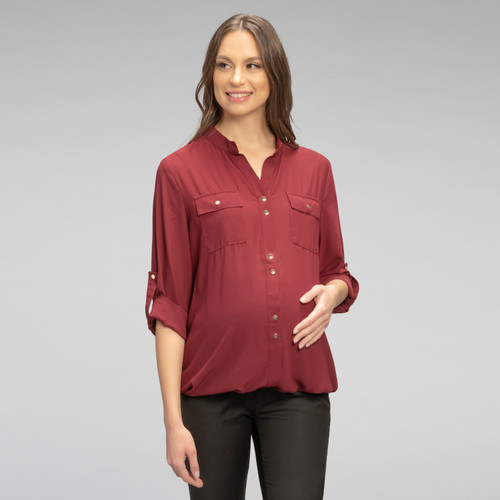 A button up maternity blouse made with sheer breathable fabric, featuring two pockets on the chest, light gold snap buttons and cuffed sleeves that can be worn long or rolled up and secured with matching light gold snap button strap.